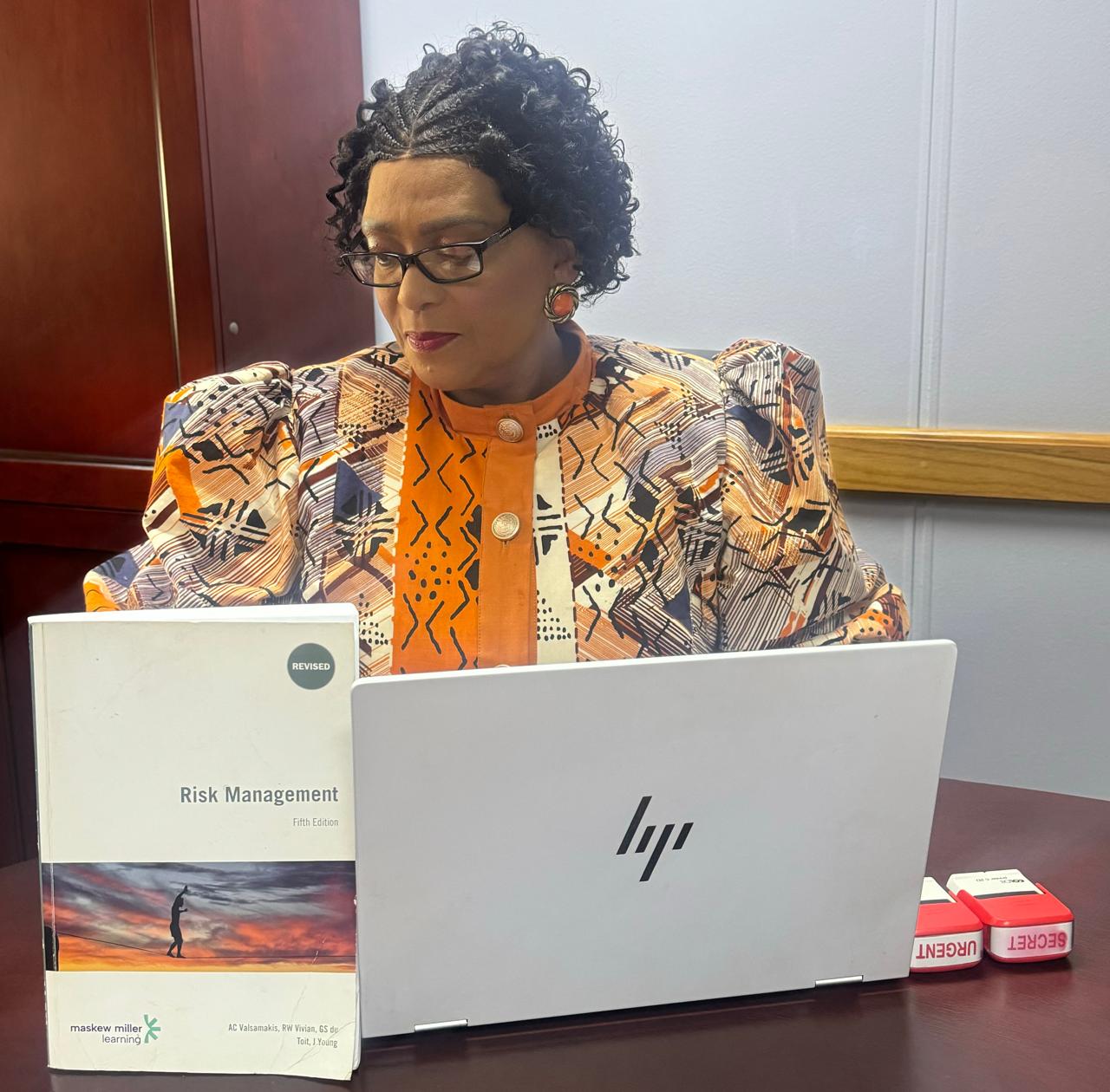 GRC'ore founder reviewing risk management at her desk